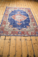 Distressed cobalt blue field and faded rust corner spandrel of vintage Oushak rug.