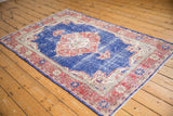 Vintage Distressed Oushak rug corner, cobalt blue field, faded rust spandrel, and floral borders.