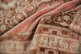 Distressed Vintage Oushak rug texture, coffee brown and faded raspberry geometric motifs.