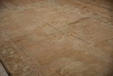 Textured detail of vintage distressed Oushak rug pile, showing tree of life and starburst patterns.