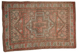 Distressed Vintage Oushak carpet with geometric medallions in blush, seafoam, and ivory.