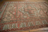Distressed Oushak rug border, with seafoam green wave motif and blush, time-softened tones.