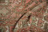 Distressed pile texture and traditional blush, sage, brown patterns on a vintage Oushak rug.