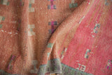 Textured vintage Oushak runner showing geometric patterns, even wear, and faded blush tones.