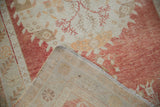 Vintage Distressed Oushak rug with worn pile, secured side cord, and woven foundation.