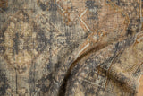 Distressed Melas rug texture detail, with worn pile, exposed foundation, and muted charcoal-gold tones.