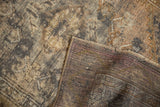 Distressed hand-knotted Melas rug pile showing visible foundation and reverse weave.