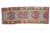 Distressed 1950s Oushak runner with pink fuchsia rose bouquets, ivory field, rust starburst border.