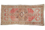 Distressed Oushak rug runner, faded raspberry red medallion, light field, and bronze patterns. 4'9