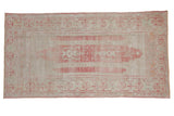 Distressed vintage Oushak runner, pale raspberry red, beige, with faded plant and ram's horn motifs. 3'3