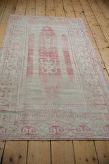 Distressed Oushak runner border with ram's horn motifs and abrashed raspberry pink field.