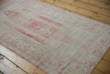 Distressed Oushak rug border with ram's horn pattern and abrashed pale tones.