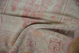 Textured pile and faded raspberry pink side selvage on this vintage Oushak runner.