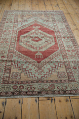Distressed vintage Oushak rug border and serrated geometric patterns in cherry red and silver.