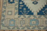Distressed vintage Oushak border with serrated leaf motifs, indigo, pale denim blue, ivory.