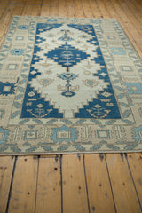 Vintage distressed Oushak carpet with indigo and ivory stepped medallion, Samovar border, 5'2