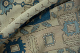 Distressed Oushak carpet pile texture featuring indigo and pale blue serrated leaf designs.