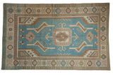 Distressed vintage Oushak rug, denim blue field, geometric medallion, beige and pale rose, 5'1