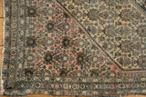 Antique Farahan Sarouk corner showcasing dusty rose and ivory fields, henna plant motif, and patterned border.