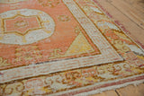 Vintage Khotan runner corner, pale orange field, ivory cloud band border, with worn pile areas.