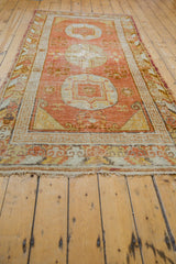 Vintage Khotan rug runner's end fringe, terracotta and ivory geometric border.