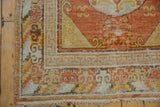 Vintage Khotan runner: running infinity border in terracotta, ivory, gold, and worn fringe.