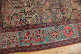 Rare oxidized copper green main border with floral vinery on an antique Farahan Sarouk rug.