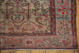 Corner detail of a Farahan Sarouk rug featuring its rare copper green border and golden field.