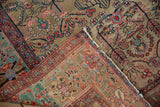 Pliable foundation and floral pile of a hand-knotted Farahan Sarouk rug's folded corner.