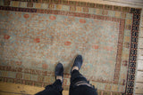 Vintage distressed Khotan rug, displaying its faded slate blue field and terracotta pomegranate design.
