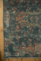 Distressed Mahal runner's worn texture, exposed foundation, blue and red tones, and short fringe.