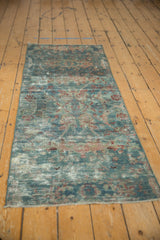 Textured distressed pile of vintage Mahal runner showing faded blue, red floral vinery.