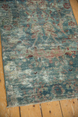 Distressed vintage Mahal runner fragment, highlighting faded blues, cherry reds, and exposed foundation.