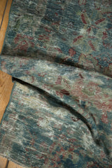 Distressed vintage Mahal rug's worn texture, highlighting blue, red, ivory floral patterns.