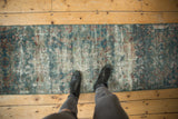 Distressed vintage Mahal runner with exposed foundation and faded blue and red floral pattern.