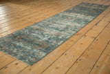 Distressed vintage Mahal rug runner with visible foundation, showing faded blue and red floral vinery.