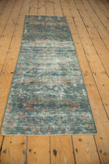 Distressed Mahal runner fragment showing foundation wear, faded floral texture, and blue-red colors.