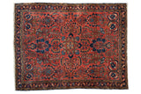 Vintage Lilihan rug with central floral pomegranate medallion, brick red, navy blue, dusty gold motifs.