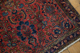 Vintage Lilihan rug's navy blue and gold border detail with aged fringe.