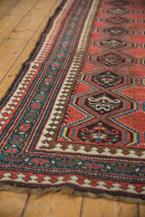 Antique Caucasian runner side: madder red field, borders with reciprocating pawn motif, even wear.