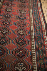 Antique Caucasian runner's madder root red geometric medallions and reciprocating pawn motif border.