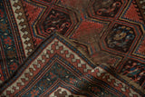 Antique Caucasian runner's folded corner highlights geometric pawn motif border in madder red and ivory.