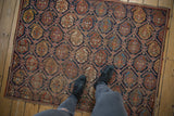 Antique Afshar rug showcasing lattice-oriented boteh motifs and rich, time-softened hues.
