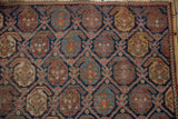 Indigo, brick red, and saffron boteh design motif on this hand-knotted Afshar rug, revealing knot heads.