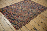 Antique Afshar rug's allover boteh lattice, with indigo, brick red, and foundation showing through.