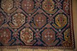 Intricate boteh motifs in lattice panels on antique Afshar rug, with indigo, brick red, and low pile texture.
