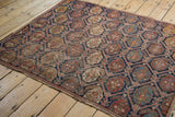 Antique Afshar rug's repeating indigo blue lattice, brick red boteh, and narrow outer border.