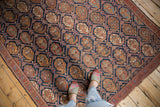 Antique Afshar rug with detailed allover boteh design, indigo ground, and brick red lattice.