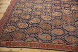 Antique Afshar rug's indigo lattice, repeating saffron boteh motif, and brick red border.
