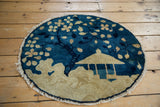 Pictorial design of flowering tree branches with beige blossoms on deep blue, showing worn fringe.